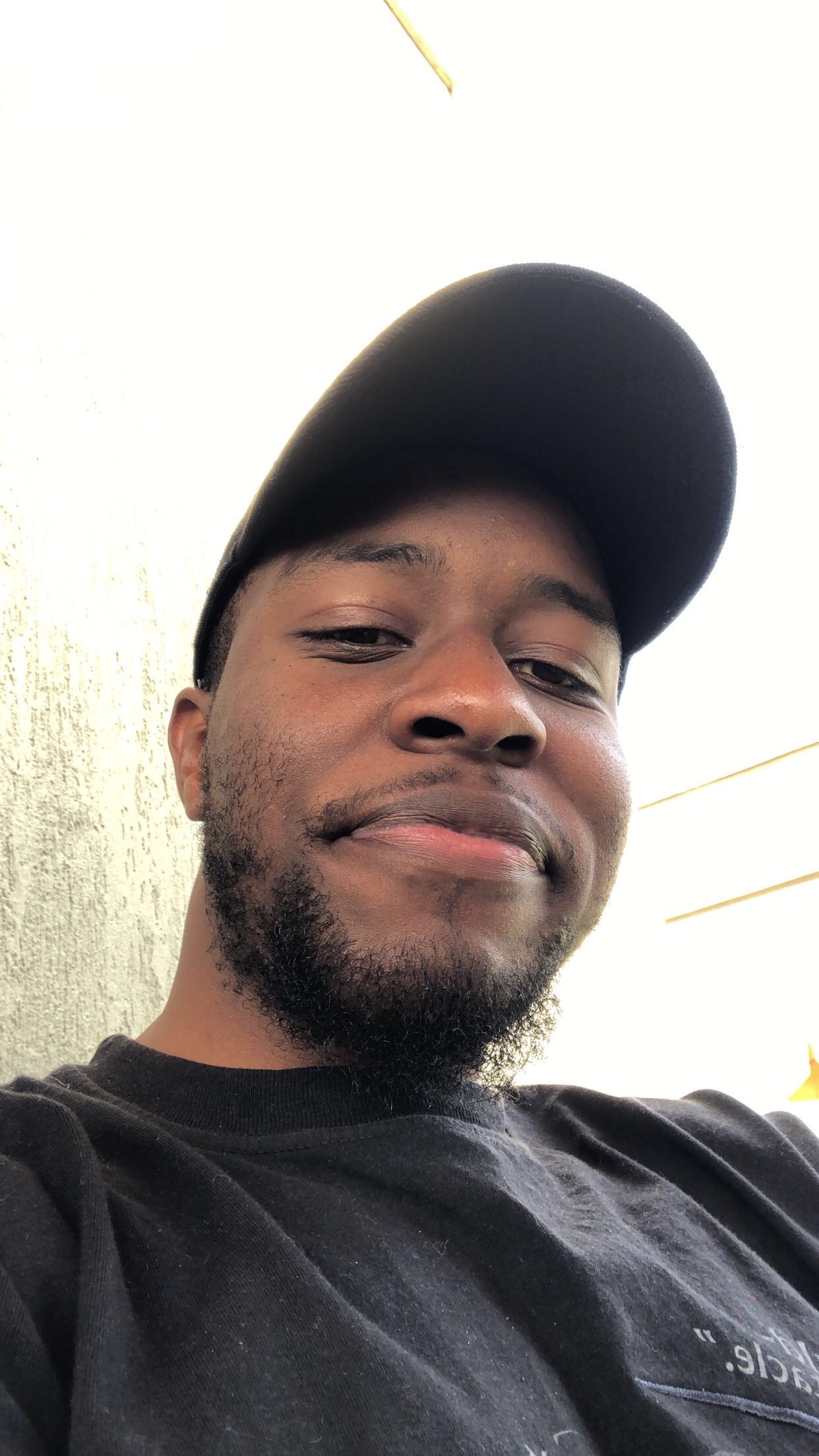 A close up of the website owners face. The individual is wearing a hat and smiling